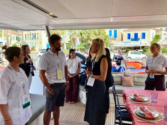 Our Broker Sarah Klische talking to the Crew onboard Catamaran Namaste at the East Med Yacht Show 2024